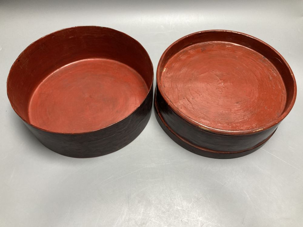 A Burmese red lacquered cylindrical box and a William Crawford biscuit tin (2)